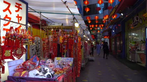 People-Walking-Through-Arcade-Selling-Decoration-For-Chinese-New-Year---Close-Up-Shot
