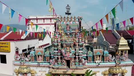 Sri-Mariamman-Hindu-Temple-Little-India-Queen-Street-with-elaborate-deity-altar-on-top,-Aerial-drone-left-pan-shot