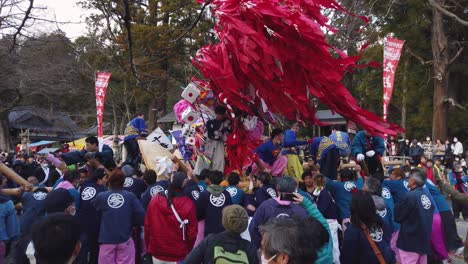 Slow-motion-shot-of-Sagicho-Matsuri-festival,-float-battle-with-gathered-crowd