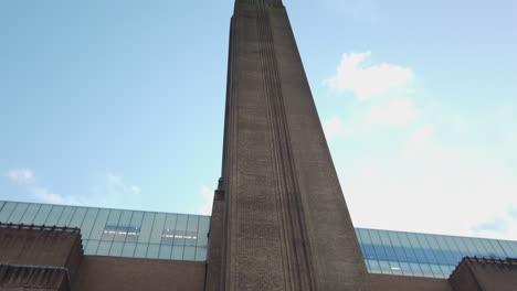 Panning-up-the-tall-chimney-looking-tower-of-the-iconic-Tate-Modern-art-gallery-museum-building-in-the-city