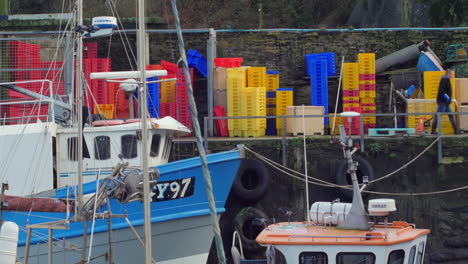 Fisherman-working-on-Mevagissey-harbour-side,-pulling-pallet-truck