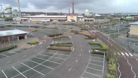 Aerial-view-deserted-retail-store-parking-areas-COVID-corona-virus-lockdown-low-dolly-right