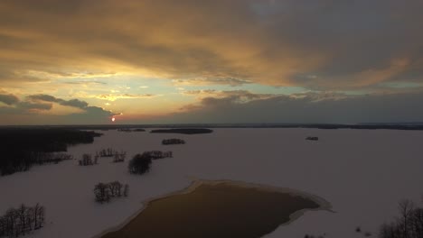 Beautiful-aerial-establishing-shot-of-arctic-region-during-sun-rising-on-the-snow