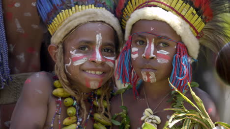 Two-native-friends-smile-happily-at-camera-with-indigenous-headdress-and-costume-on-at-Goroka-Show-in-Goroka,-Papua-New-Guinea