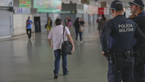 Brazilian-military-police-standing-on-patrol-of-a-marketplace-in-Brasilia-during-Covid-19-crisis