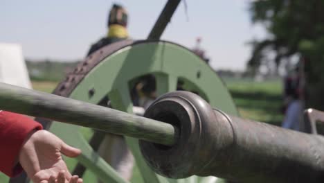 Cleaning-a-cannon-barrel-at-a-reenactment-of-the-Battle-of-Waterloo,-cinematic-slow-motion