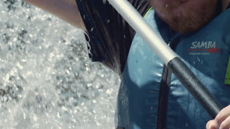 Splashing-water-over-kayaker-face-on-wild-river,-extreme-closeup,-slow-motion