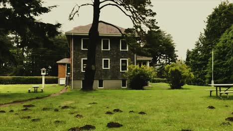 Walking-in-the-mole-mound-covered-yard-toward-the-Museum-at-the-Port-Orford-Heads,-Oregon-in-the-Pacific-Northwest