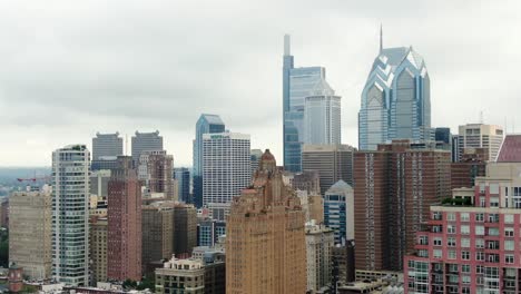 Slow-aerial-pan-of-Philadelphia-USA-skyscraper-skyline-on-cloudy-overcast-rainy-day,-financial-district