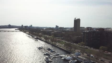 Contemporary-Buildings-And-Bustling-Streets-At-The-Bay-Of-Charles-River,-View-In-Cambridge,-Massachusetts---aerial-drone---out-of-focus