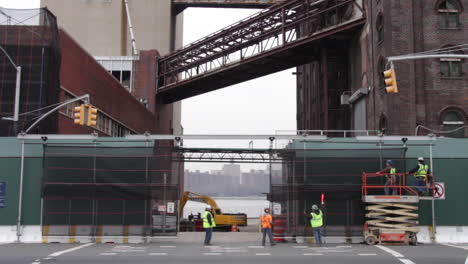 Domino-Sugar-Factory-Redevelopment-in-Williamsburg,-Construction-Pan-Down-Future-High-Rise-to-Street-Level