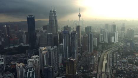Cityscape-Aerial-Shot-Of-Kuala-Lumper,-Travel-Destination-Backlit-At-Sunset