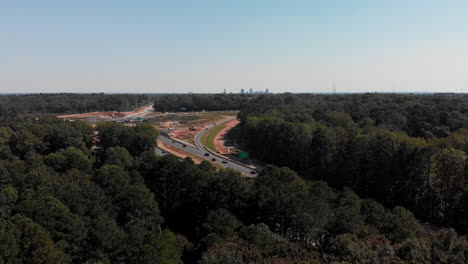 Drone-shot-of-highway-with-downtown-Raleigh-North-Carolina-in-distance