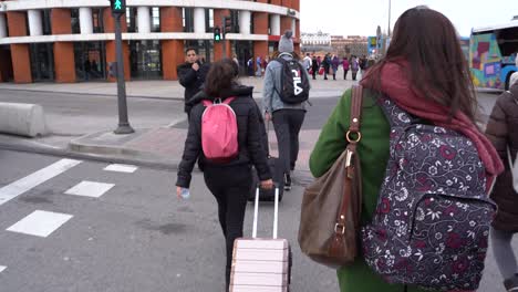 Commuters-Crossing-The-Street,-Walking-Towards-The-Atocha-Railway-Station-In-Madrid,-Spain---full-shot