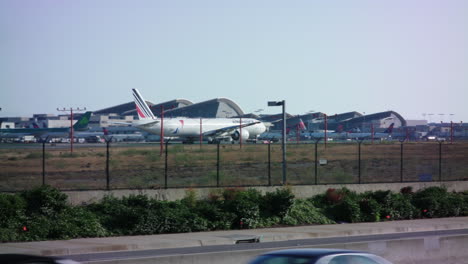 An-Air-France-commercial-airplane-drives-along-the-tarmac-next-to-the-terminals-at-LAX-before-departure