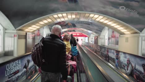 Travellator---Train-Passengers-With-Luggage-Riding-On-A-Moving-Walkway-In-Atocha-Railway-Station,-Madrid,-Spain---Medium-Shot