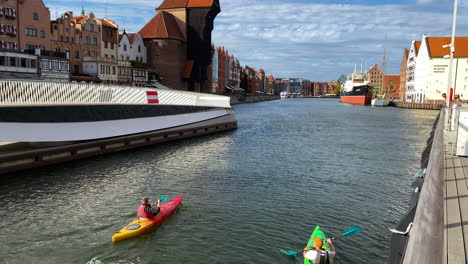 Kayaking---People-Paddling-Kayak-At-The-Old-Harbor-Canal-In-Gdansk,-Poland
