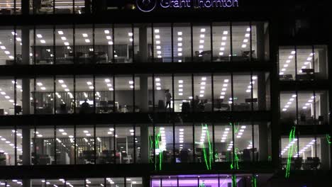 Zooming-out-shot-of-a-window-with-people-talking-in-an-office-in-the-heart-of-Dublin's-financial-district,-Dublin-Grant-Thornton-head-office-and-the-river-Liffey