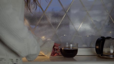 Woman-with-mug-of-fresh-brewed-coffee-in-window-medium-shot