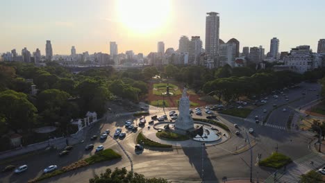 Aerial-parallax-shot-of-Libertador-Avenue,-Palermo-woods-and-Buenos-Aires-city-skyline-at-golden-hour