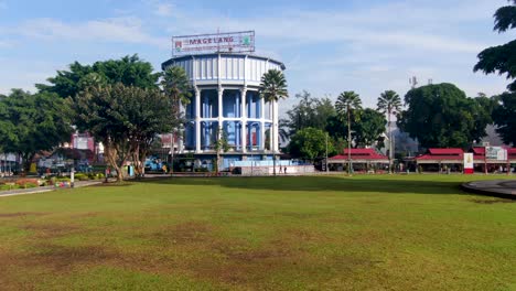 Aerial,-historic-water-container-on-town-square-Magelang-Big-Stove,-Indonesia
