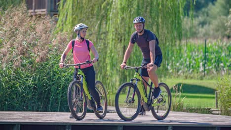 Pareja-Montando-Juntos-En-Bohinj-En-Tablas-De-Madera-Cerca-Del-Lago