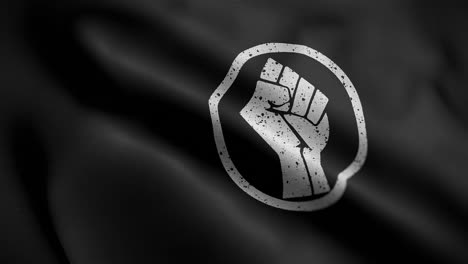 Angled-view-of-the-Black-and-White-Fist-of-Power-Flag-flapping-in-HD