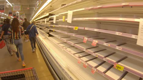 Customers-looking-for-food-to-purchase-amid-empty-shelves-and-purchase-limits-at-HEB-grocery-store