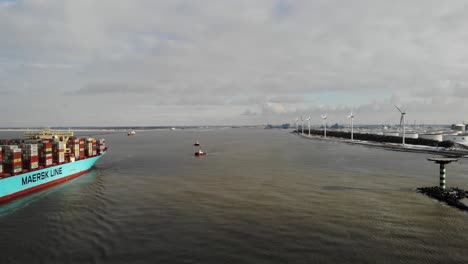 Two-small-tug-boats-waiting-to-assist-the-giant-vessel-Marstal-Maersk-to-guide-the-vessel-to-her-berth-while-passing-the-helicopter-platform-at-dead-slow-speed-in-the-Maasgeul