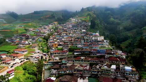 Remote-village-terraced-high-on-Mount-Sumbing-slopes,-Java,-Indonesia-aerial