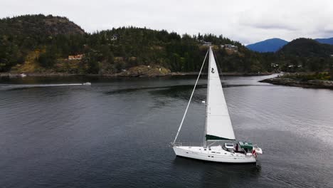 Aerial-view-of-sailboat-in-Pender-Harbour,-British-Columbia