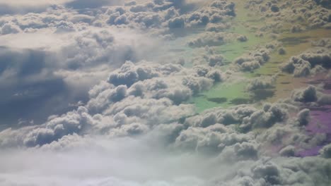 Cirrrocumulus-clouds-over-rainbow-colors-ground,-view-from-an-airplan-over-the-atlantic-ocean
