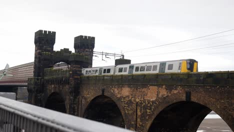 Public-train-crossing-Runcorn-bridge-old-castle-turret-building-tower