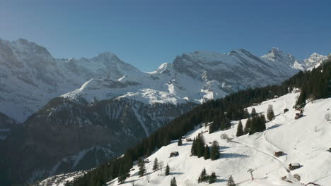 Aerial-jib-up-of-beautiful-snow-covered-Swiss-landscape
