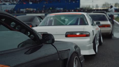 Drift-Cars-on-Racing-Track-at-Rainy-Day,-Lined-Up-for-Race,-Slow-Motion