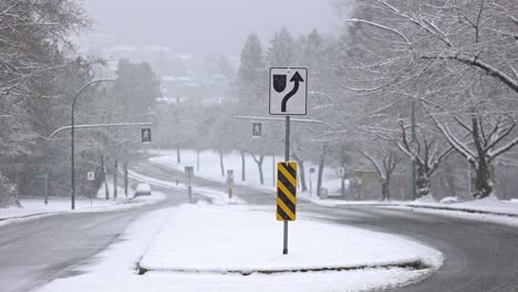 Static-shot-of-traffic-sign-on-an-empty-boulevard-road-during-blizzard