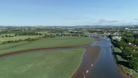 Aerial-of-the-river-Exe,-looking-inland-towards-the-motorway-flyover-and-the-city-of-Exeter