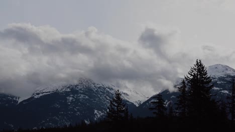 Time-lapse-of-clouds-rolling-over-snowy-mountains-in-British-Columbia,-Canada