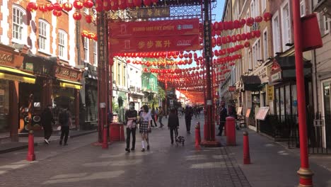 People-enjoy-a-walk-and-some-shopping-in-China-Town-London,-UK