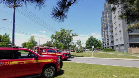 Team-of-firefighter-vehicles-at-emergency-area-in-apartment-district