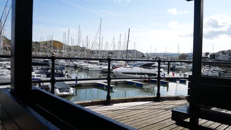 Luxury-sailboats-and-yachts-moored-Conwy-marina-shaded-seating-waterfront-North-Wales-dolly-right