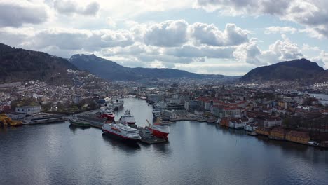 High-altitude-full-panoramic-overview-of-Bergen-city-and-harbor---Reverse-aerial---Norway