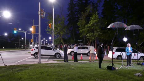 Journalist-reporting-news-at-a-terror-attack-event-beside-a-street-in-London,-Canada