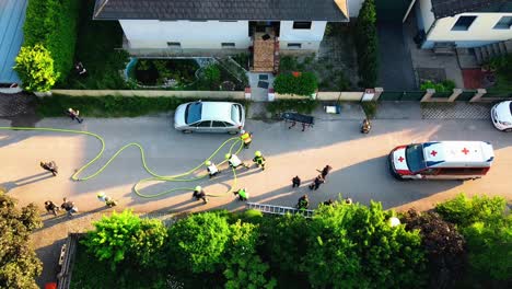 AERIAL---Firefighters,-police-and-paramedics-at-fire-in-Oberwaltersdorf,-Austria