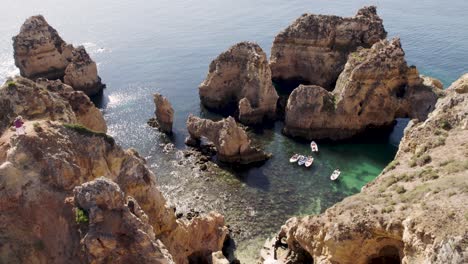Visitors-taking-photos-on-top-of-cliff,-Lagos-,-Algarve