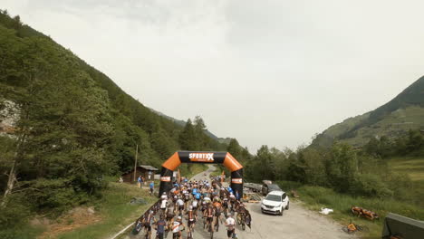 FPV-Of-Mountain-Bikers-At-The-Start-Of-The-Raid-Evolenard-2021-Race-In-Val-d'Herens-In-Valais,-Switzerland