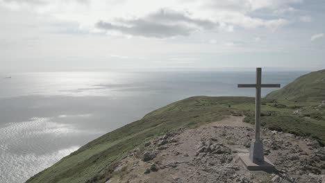 Cross-On-The-Top-Of-The-Bray-Head-Mountain-In-Bray-Town-County-In-Wicklow,-Ireland---aerial-drone-shot