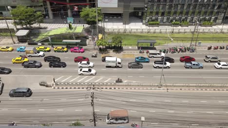 High-angle-view-of-Traffic-around-Ratchadaphisek-Road,-Rama-9-Intersection,-near-department-stores-during-the-Covid-19-situation-in-Bangkok,-Thailand