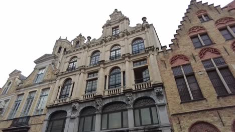 Walk-past-medieval-buildings-and-facades-in-Bruges,-the-capital-of-West-Flanders-in-northwestern-Belgium