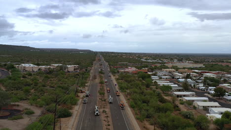 Aerial-flying-over-highway,-city-crew-fixes-damaged-pole-after-hurricane,-Arizona
